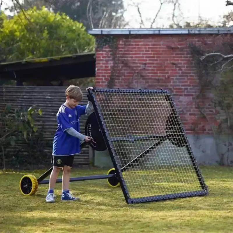 kid setting up m-station football kickback net trampoline rebounder by Munin Sports